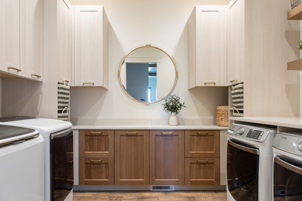 Example of a large farmhouse u-shaped dedicated laundry room design in Salt Lake City with a side-by-side washer/dryer