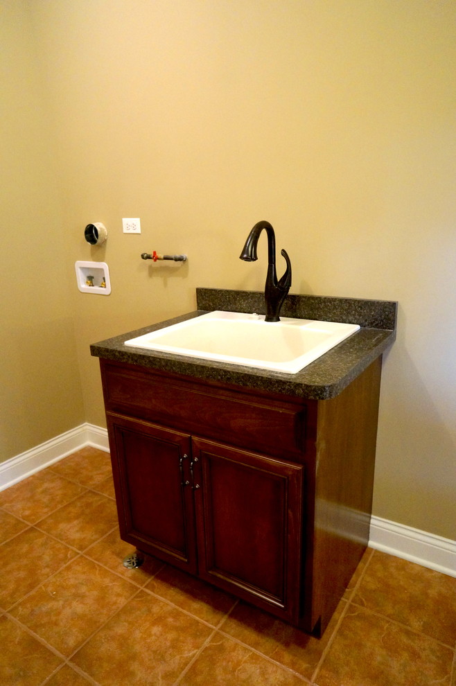 Mid-sized elegant ceramic tile utility room photo in Chicago with a drop-in sink, beige walls and a side-by-side washer/dryer