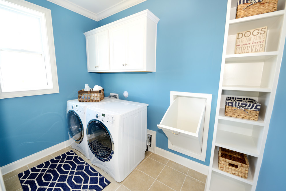 Immagine di una sala lavanderia classica con ante bianche e lavatrice e asciugatrice affiancate
