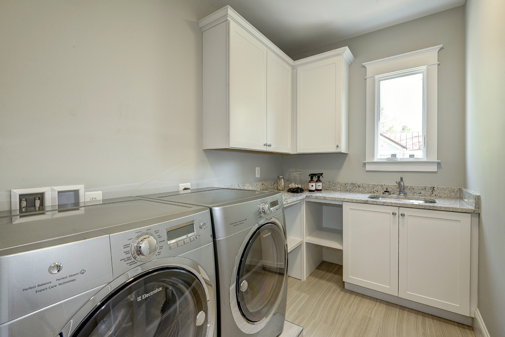 Medium sized modern l-shaped separated utility room in DC Metro with a single-bowl sink, shaker cabinets, white cabinets, granite worktops, beige walls and a side by side washer and dryer.