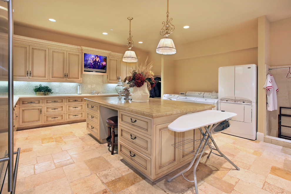 Expansive mediterranean u-shaped utility room in Orange County with recessed-panel cabinets, limestone worktops, limestone flooring, a side by side washer and dryer, beige cabinets and beige walls.