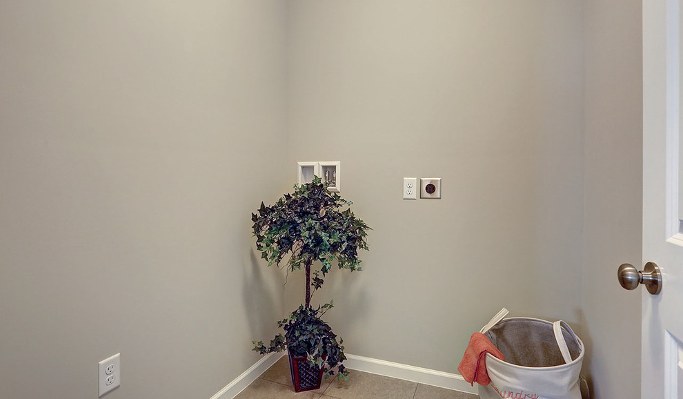 This is an example of a medium sized traditional separated utility room in Other with ceramic flooring and beige floors.