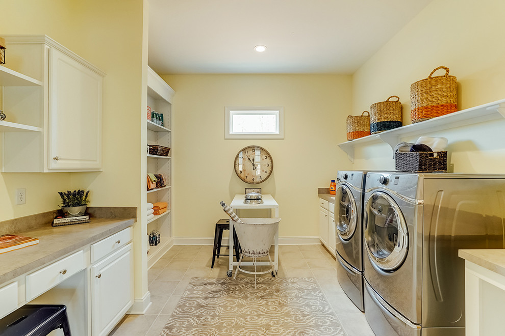 Large elegant u-shaped vinyl floor utility room photo in Richmond with a drop-in sink, beaded inset cabinets, white cabinets, laminate countertops, beige walls and a side-by-side washer/dryer