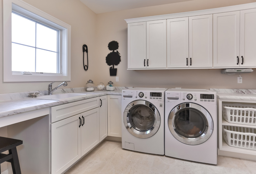 Photo of a classic utility room in Milwaukee with recessed-panel cabinets.