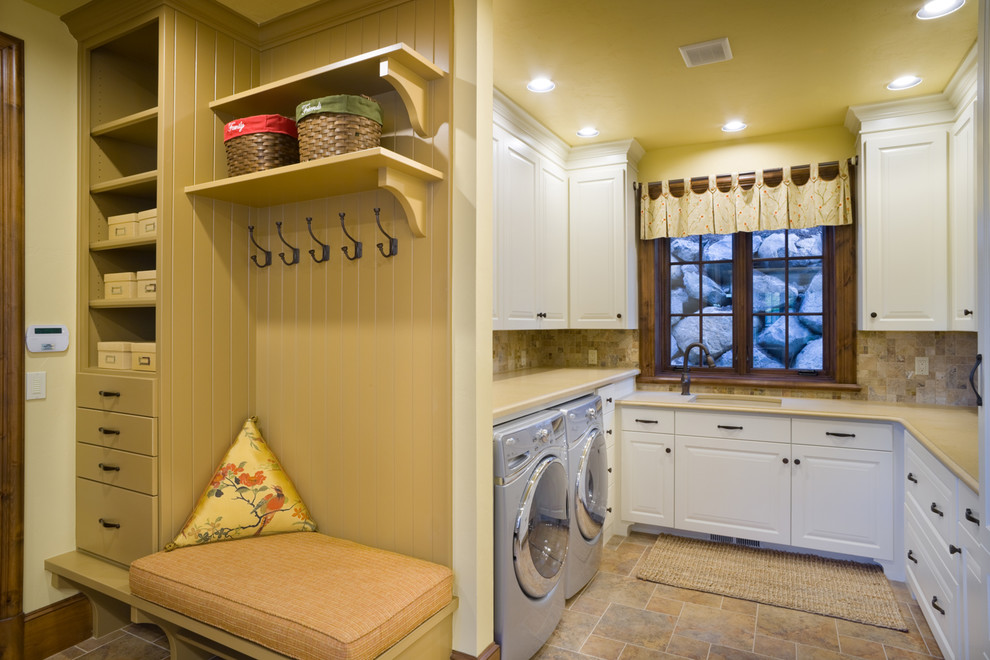 Example of a classic u-shaped laundry room design in Portland with a side-by-side washer/dryer and beige countertops