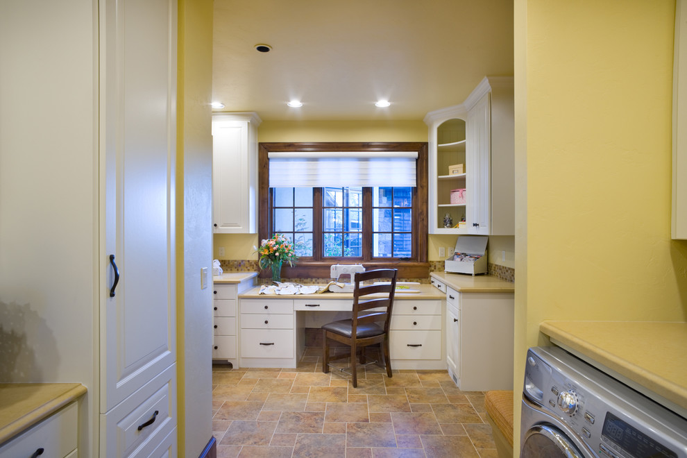 Traditional utility room in Portland with yellow walls.
