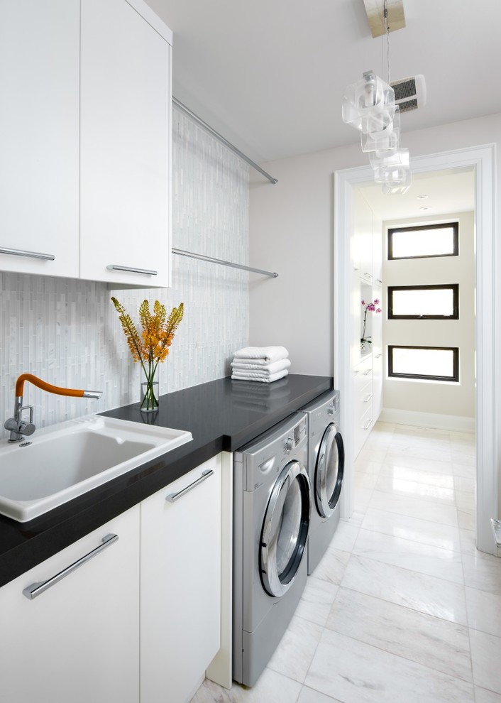 Foto de lavadero clásico renovado con puertas de armario blancas y encimeras negras