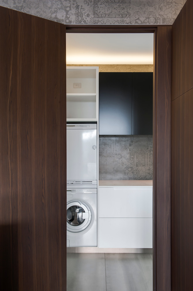 Medium sized modern l-shaped utility room in Sydney with dark wood cabinets, composite countertops, grey splashback, cement tile splashback and ceramic flooring.