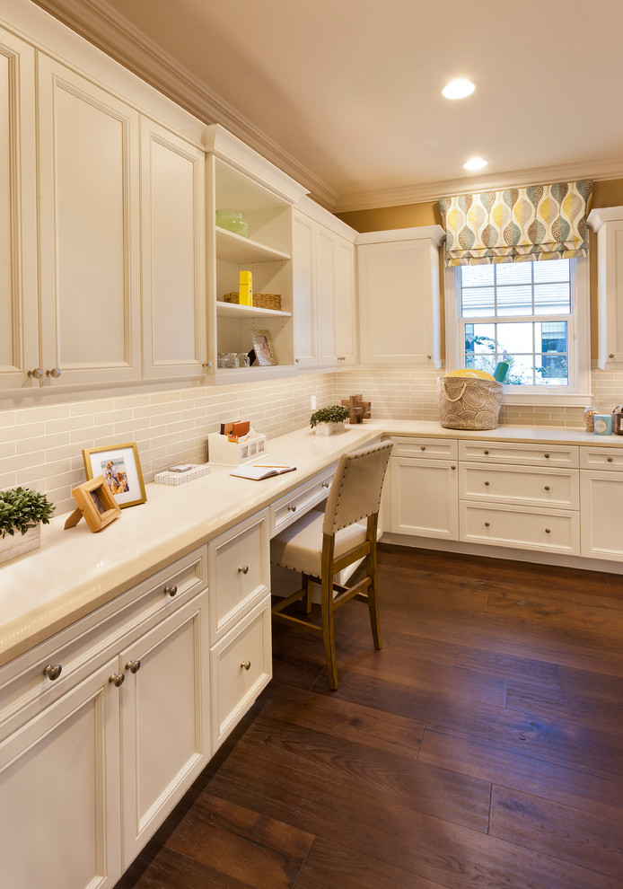 Utility room - large contemporary l-shaped dark wood floor and brown floor utility room idea in Tampa with recessed-panel cabinets, solid surface countertops, yellow walls, a side-by-side washer/dryer and white cabinets
