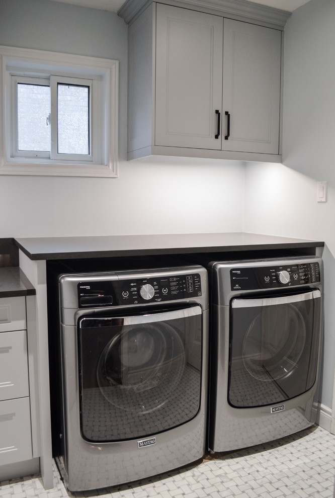 Medium sized classic galley separated utility room in Toronto with a submerged sink, shaker cabinets, grey cabinets, engineered stone countertops, grey walls, porcelain flooring, a side by side washer and dryer and multi-coloured floors.