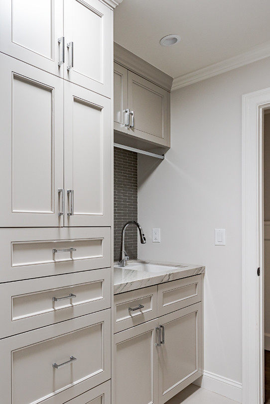 Transitional single-wall utility room photo in San Francisco with an undermount sink, beige cabinets, marble countertops, gray walls and recessed-panel cabinets