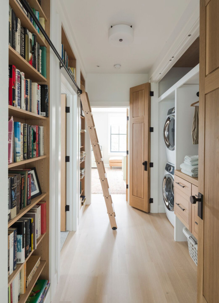 Large traditional single-wall utility room in Other with raised-panel cabinets, beige cabinets, wood worktops, white walls, a stacked washer and dryer, beige floors and beige worktops.