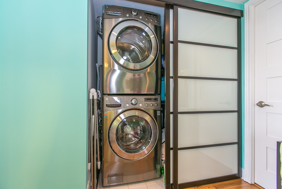 Small trendy galley laundry closet photo in Toronto with a stacked washer/dryer