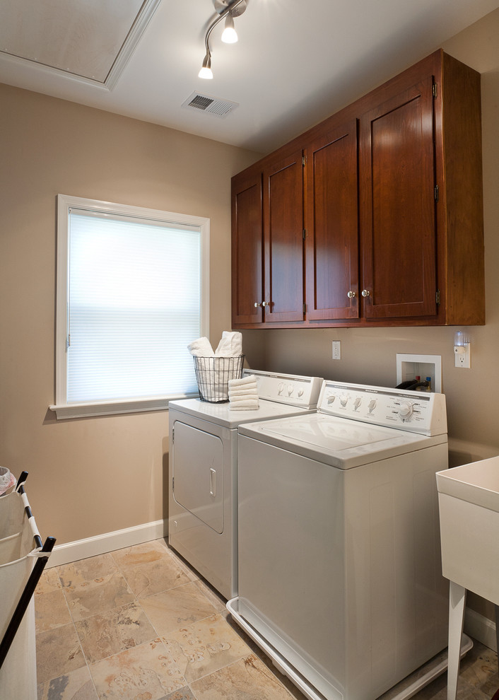 Small galley separated utility room in DC Metro with an utility sink, raised-panel cabinets, beige walls and a side by side washer and dryer.