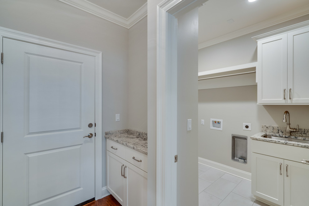 Inspiration for a timeless laundry room remodel in Other with recessed-panel cabinets, white cabinets, granite countertops, a side-by-side washer/dryer and multicolored countertops