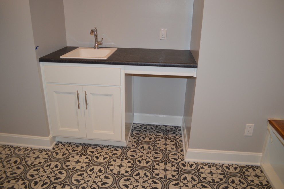 Medium sized classic single-wall utility room in Other with a built-in sink, open cabinets, white cabinets, laminate countertops, beige walls, ceramic flooring, a side by side washer and dryer and multi-coloured floors.