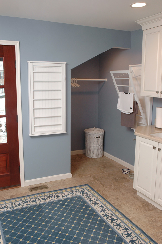 This is an example of a medium sized traditional utility room in Cincinnati with white cabinets, blue walls, porcelain flooring, a side by side washer and dryer, a submerged sink and laminate countertops.