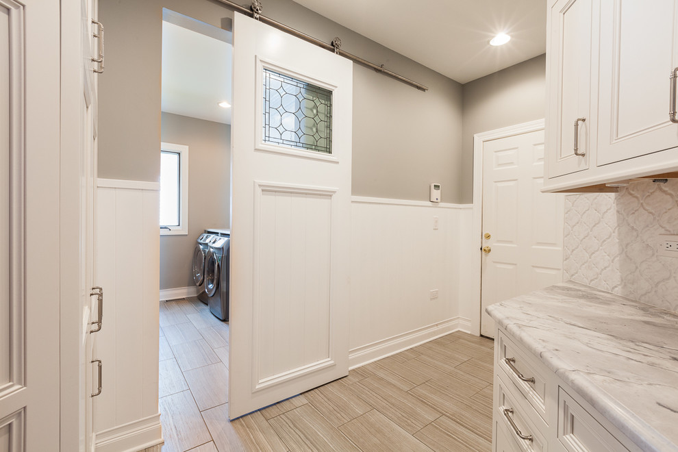 Example of a classic laundry room design in Chicago with a side-by-side washer/dryer
