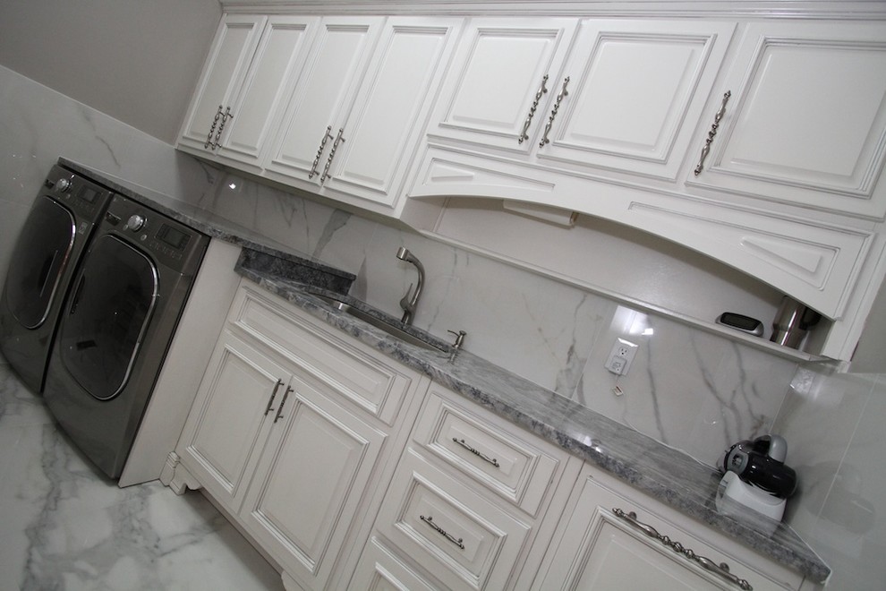 Example of a mid-sized classic u-shaped marble floor dedicated laundry room design in Atlanta with an undermount sink, raised-panel cabinets, white cabinets, granite countertops, white walls and a side-by-side washer/dryer