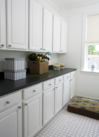 This is an example of a traditional utility room in New Orleans with white floors.