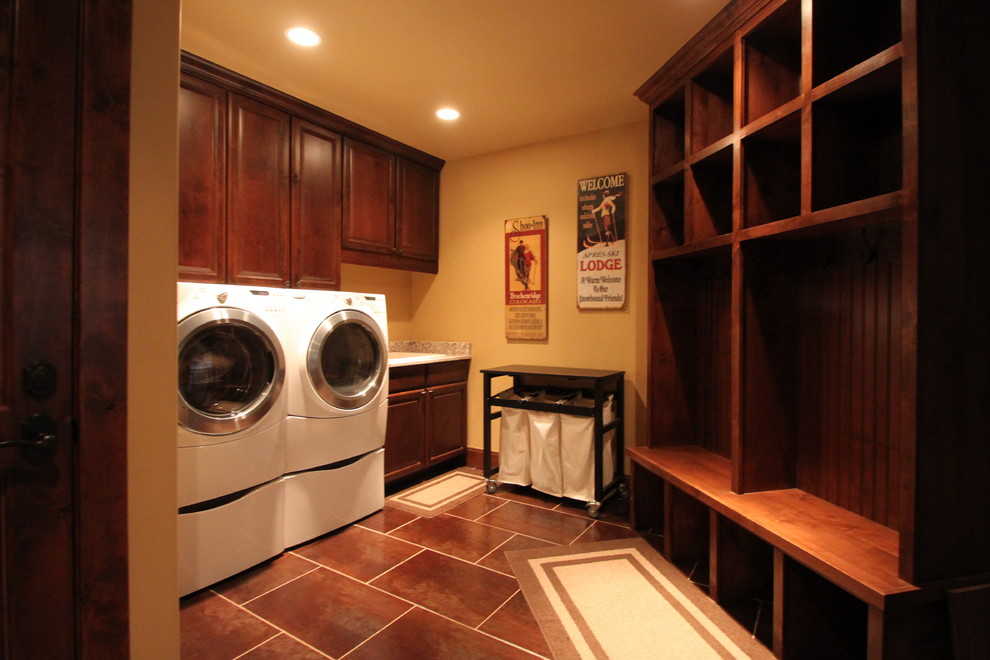 Laundry room - traditional brown floor laundry room idea in Denver