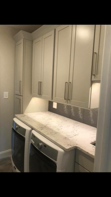 Small modern separated utility room in Philadelphia with a submerged sink, shaker cabinets, beige cabinets, engineered stone countertops, grey walls, porcelain flooring, a side by side washer and dryer and grey floors.