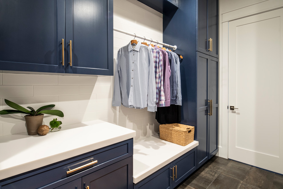 This is an example of a medium sized classic galley separated utility room in Los Angeles with a submerged sink, shaker cabinets, blue cabinets, composite countertops, white walls, concrete flooring, a side by side washer and dryer, grey floors and white worktops.
