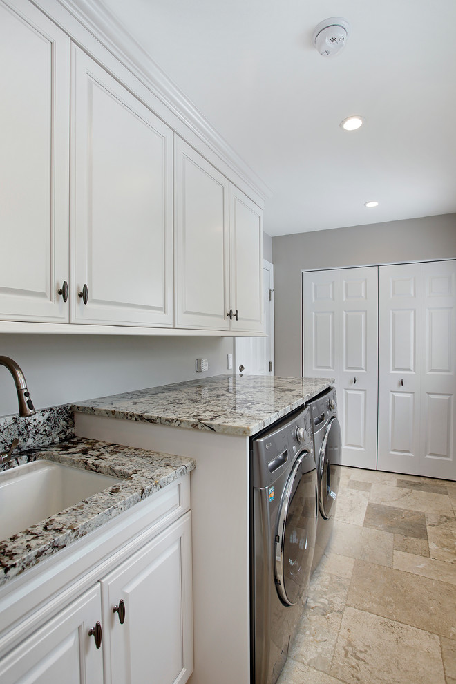 Inspiration for a small transitional single-wall ceramic tile utility room remodel in Chicago with an undermount sink, raised-panel cabinets, white cabinets, granite countertops, gray walls and a side-by-side washer/dryer