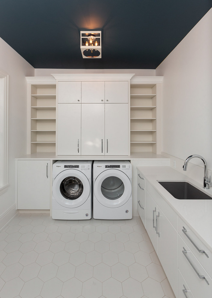 Huge transitional l-shaped ceramic tile and white floor dedicated laundry room photo in Detroit with an undermount sink, flat-panel cabinets, white cabinets, quartzite countertops, white walls, a side-by-side washer/dryer and white countertops