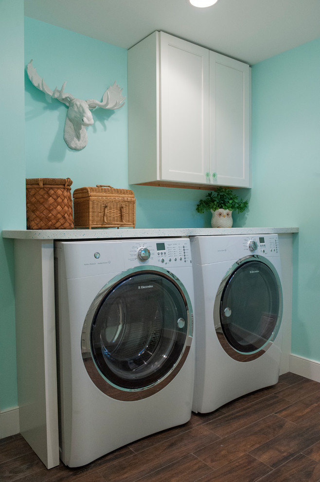 Design ideas for a contemporary utility room in Wilmington with white cabinets, blue walls and a side by side washer and dryer.