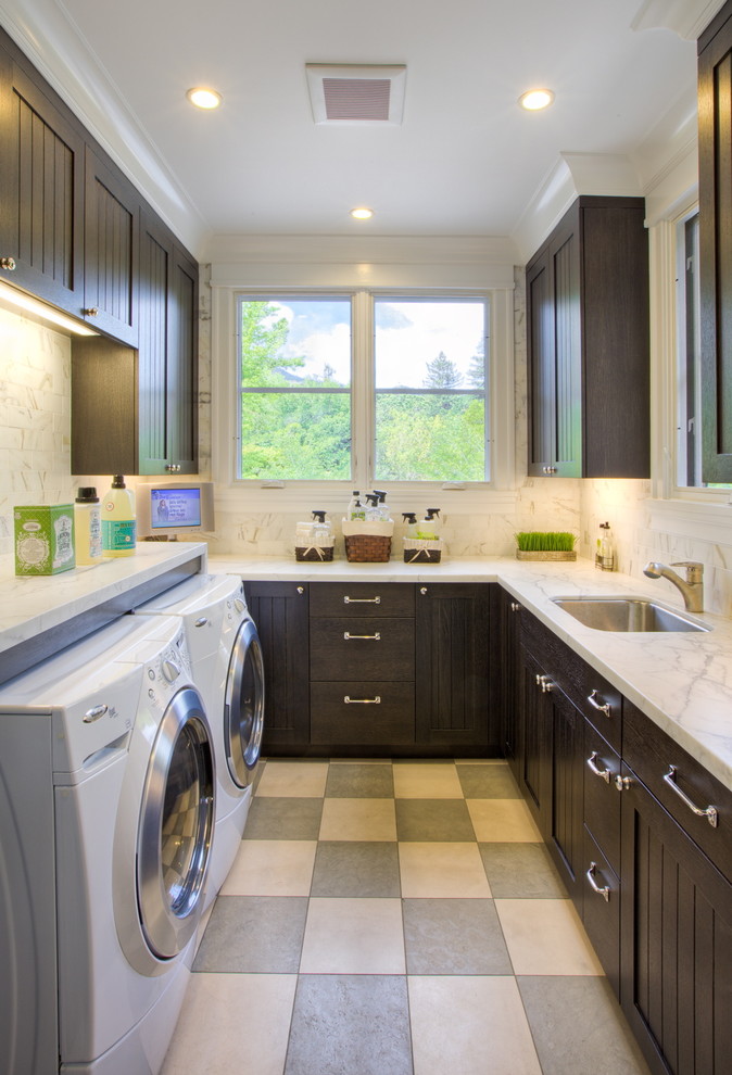 Ornate u-shaped multicolored floor dedicated laundry room photo in San Francisco with dark wood cabinets and a side-by-side washer/dryer