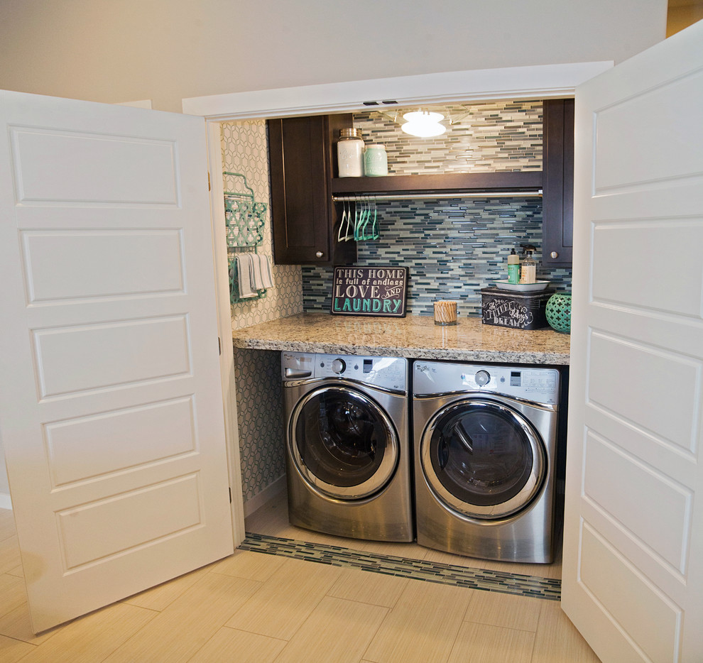 This is an example of a small classic single-wall laundry cupboard in Austin with shaker cabinets, dark wood cabinets, granite worktops, porcelain flooring, a side by side washer and dryer and grey walls.