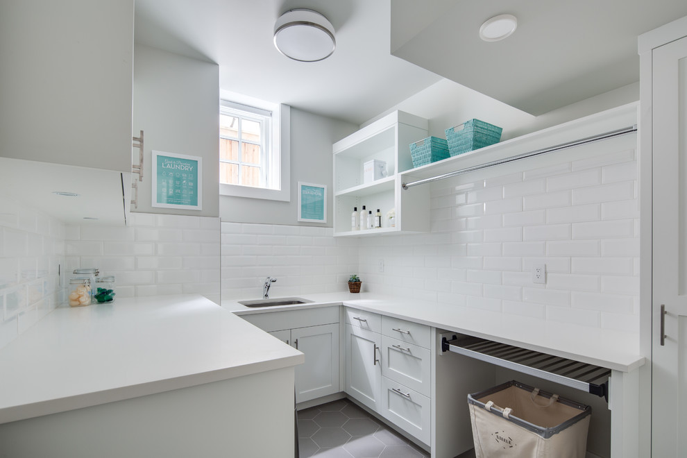 This is an example of a medium sized traditional u-shaped separated utility room in Vancouver with a submerged sink, shaker cabinets, white cabinets, engineered stone countertops, grey walls, porcelain flooring, a side by side washer and dryer, grey floors and white worktops.
