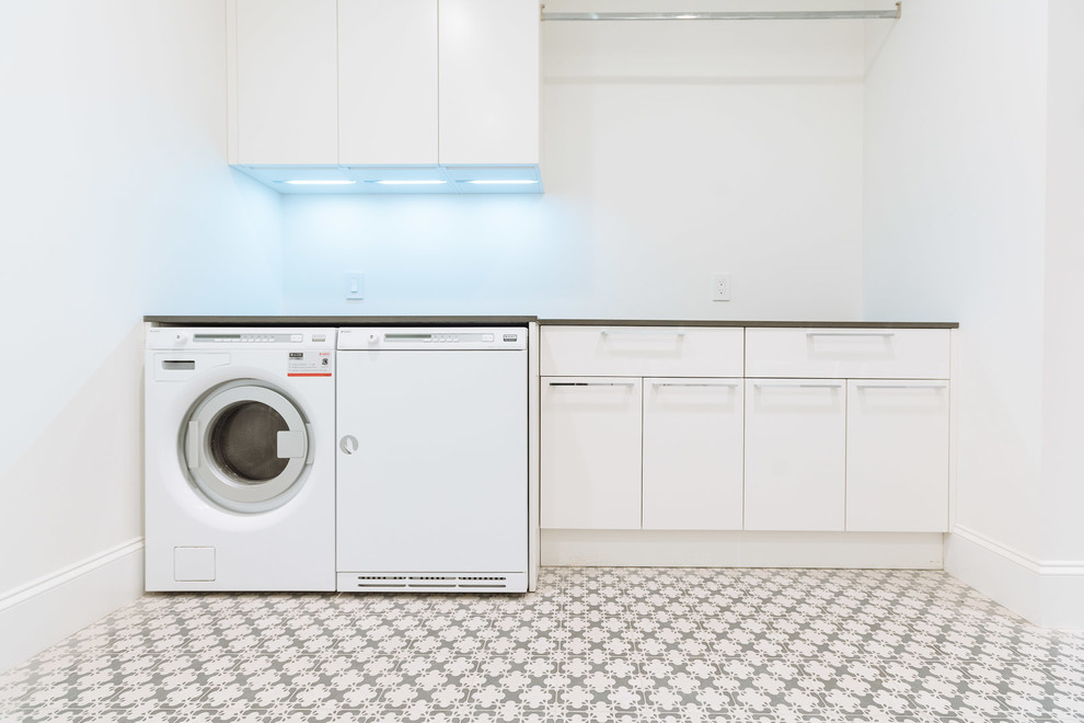 Trendy single-wall laundry room photo in Vancouver with flat-panel cabinets, white cabinets, white walls and a side-by-side washer/dryer
