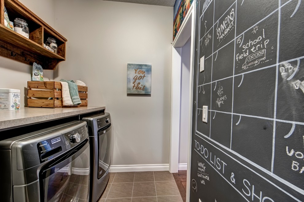 Photo of a small contemporary single-wall separated utility room in Calgary with open cabinets, brown cabinets, laminate countertops, beige walls, ceramic flooring and a side by side washer and dryer.