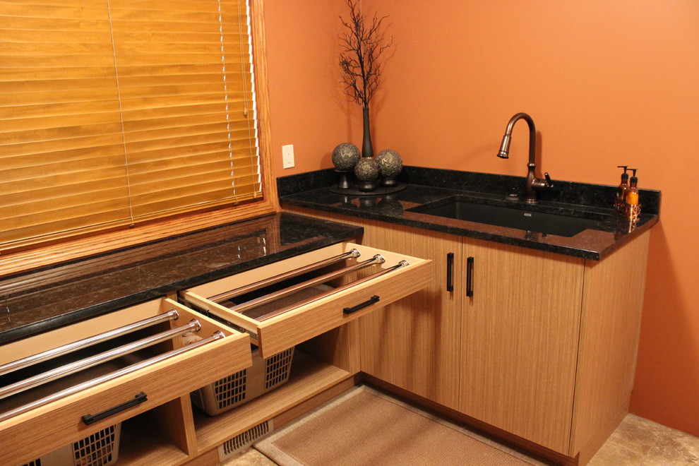 Design ideas for a medium sized world-inspired l-shaped separated utility room in Calgary with a submerged sink, flat-panel cabinets, light wood cabinets, granite worktops, orange walls, ceramic flooring and a side by side washer and dryer.