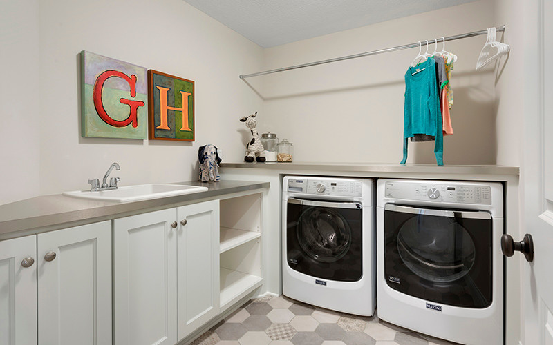 ミネアポリスにあるエクレクティックスタイルのおしゃれな洗濯室 (L型、ドロップインシンク、左右配置の洗濯機・乾燥機) の写真