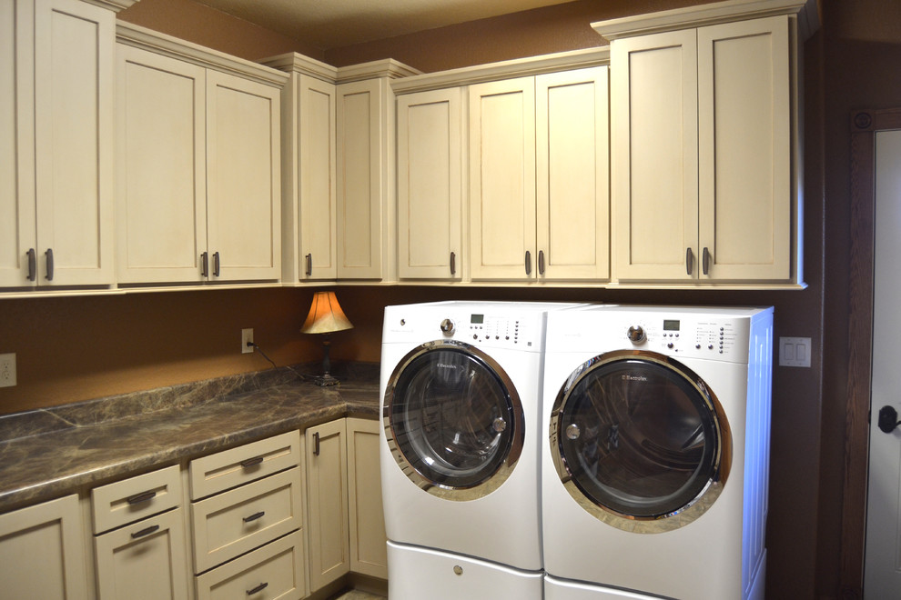 Inspiration for a large timeless l-shaped dedicated laundry room remodel in Baltimore with laminate countertops and a side-by-side washer/dryer