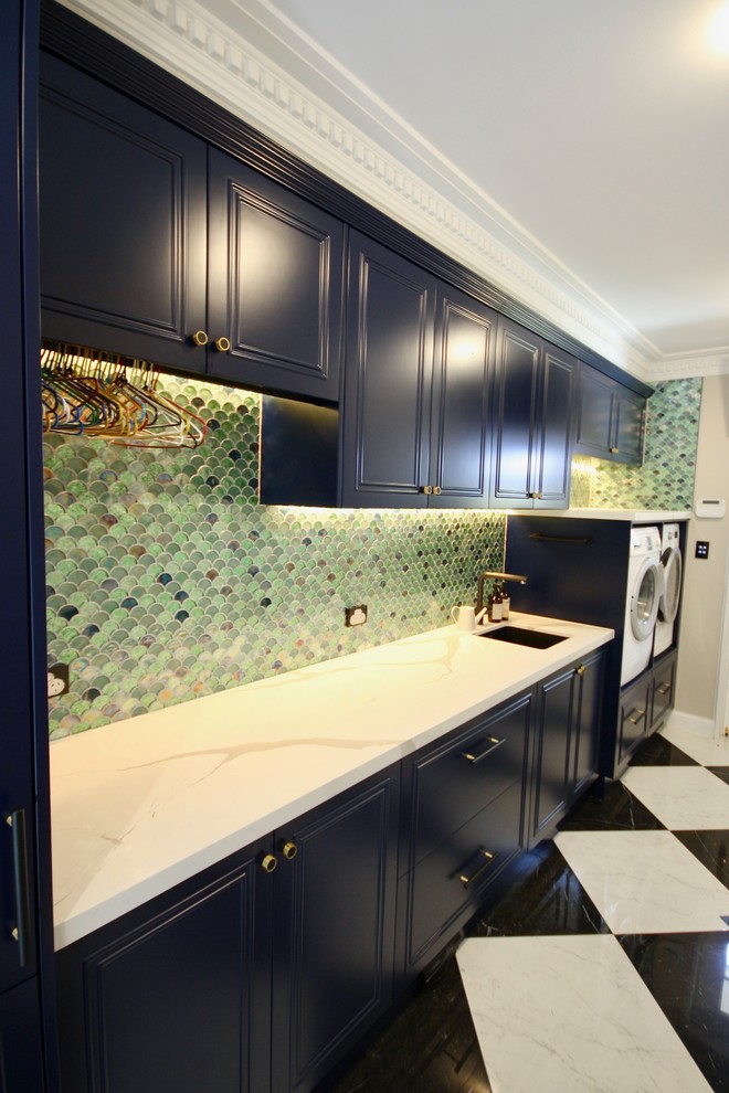 Photo of a large classic galley separated utility room in Sydney with a submerged sink, recessed-panel cabinets, blue cabinets, engineered stone countertops, white walls, marble flooring, a side by side washer and dryer, white floors and white worktops.