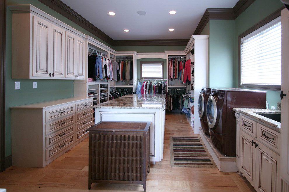 Elegant laundry room photo in Charlotte with blue walls and a side-by-side washer/dryer