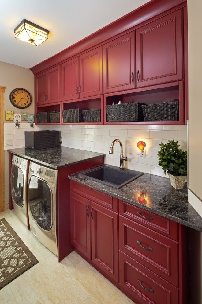 Photo of a medium sized rural single-wall separated utility room in Calgary with a built-in sink, recessed-panel cabinets, red cabinets, granite worktops, beige walls, porcelain flooring, a side by side washer and dryer and beige floors.