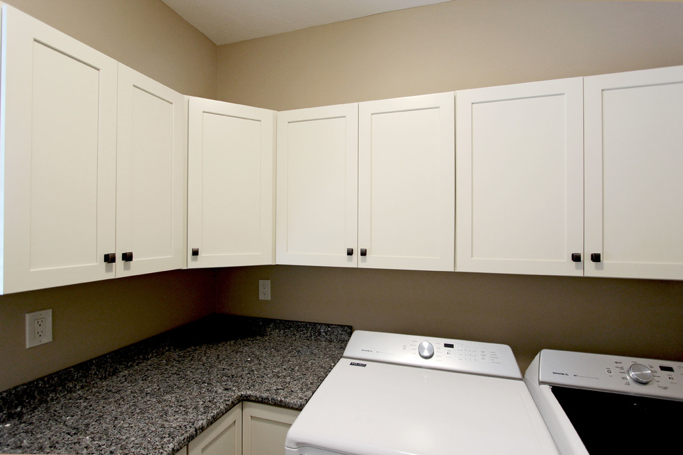 Small classic l-shaped separated utility room in Cleveland with a submerged sink, flat-panel cabinets, beige cabinets, engineered stone countertops, beige walls and a side by side washer and dryer.