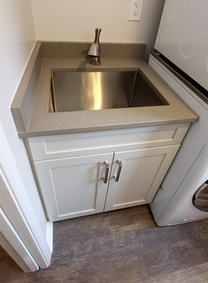 Small classic single-wall utility room in Cleveland with flat-panel cabinets and white cabinets.
