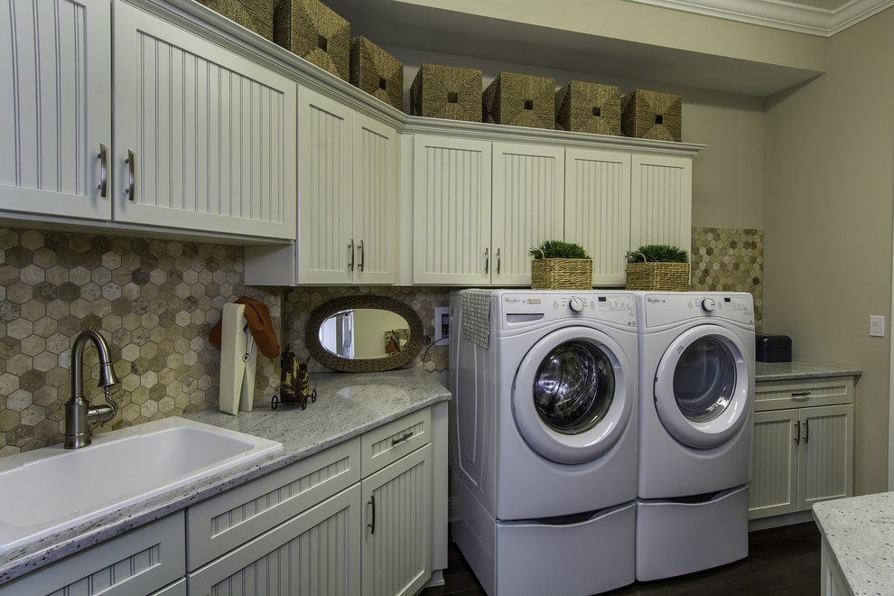 Large traditional galley separated utility room in Tampa with a built-in sink, recessed-panel cabinets, granite worktops, beige walls, dark hardwood flooring, a side by side washer and dryer and white cabinets.
