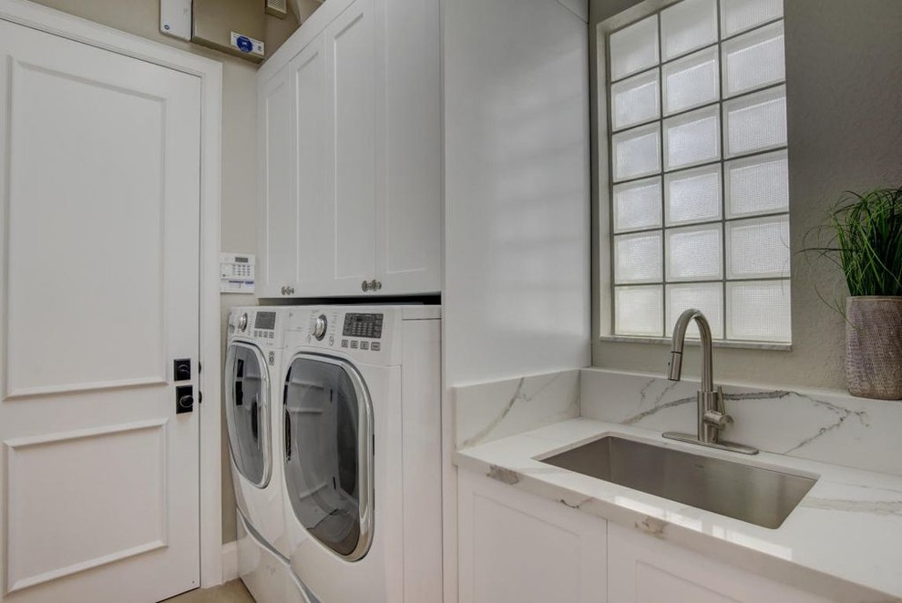 Einzeilige, Kleine Moderne Waschküche mit Unterbauwaschbecken, Schrankfronten im Shaker-Stil, weißen Schränken, Quarzwerkstein-Arbeitsplatte, grauer Wandfarbe, Porzellan-Bodenfliesen, Waschmaschine und Trockner nebeneinander und beigem Boden in Miami