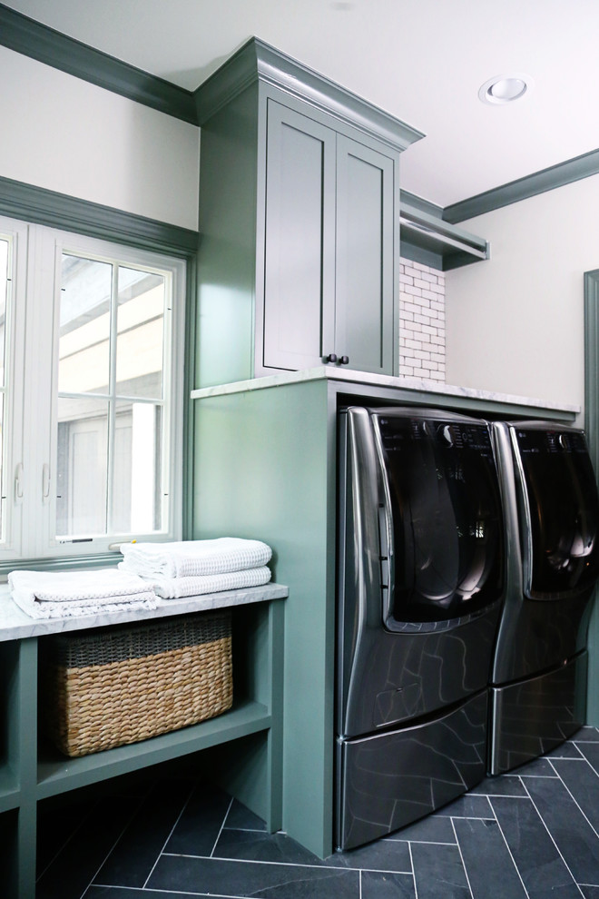 Design ideas for a medium sized traditional galley utility room in Other with a submerged sink, shaker cabinets, green cabinets, marble worktops, white walls, vinyl flooring, a side by side washer and dryer, grey floors and grey worktops.