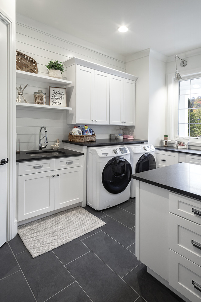 Photo of a classic utility room in Detroit with a built-in sink, shaker cabinets, white cabinets, white walls, ceramic flooring, a side by side washer and dryer, brown floors and brown worktops.