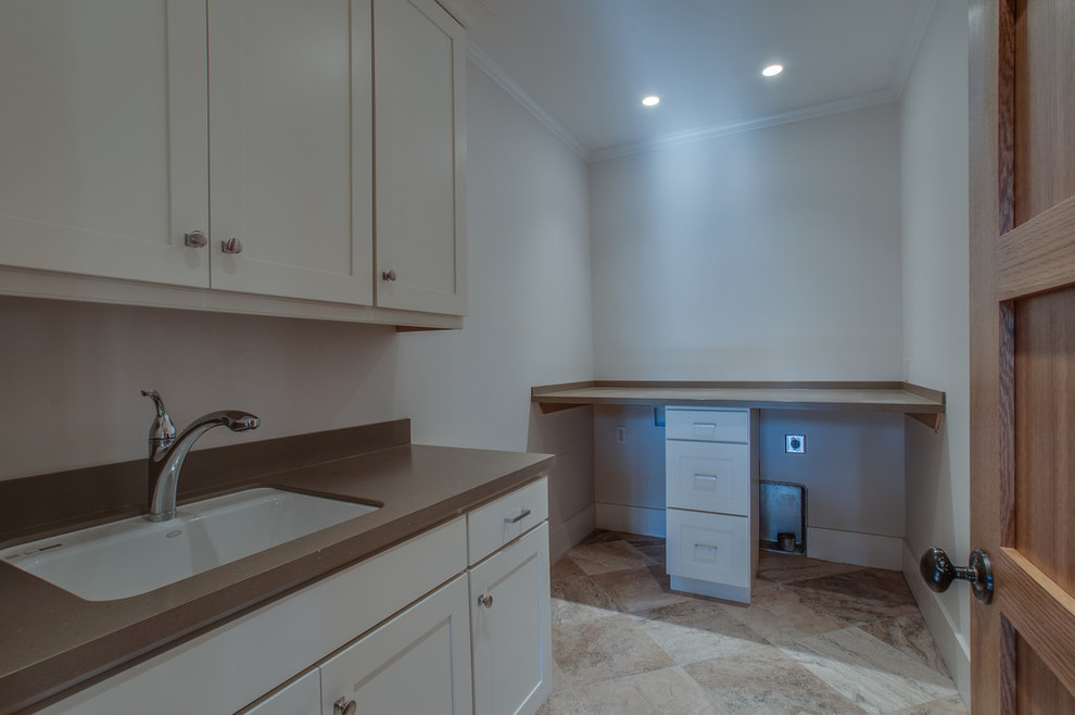 Photo of a large traditional l-shaped separated utility room in Nashville with a submerged sink, shaker cabinets, white cabinets, engineered stone countertops, grey walls, porcelain flooring, a side by side washer and dryer, multi-coloured floors and brown worktops.
