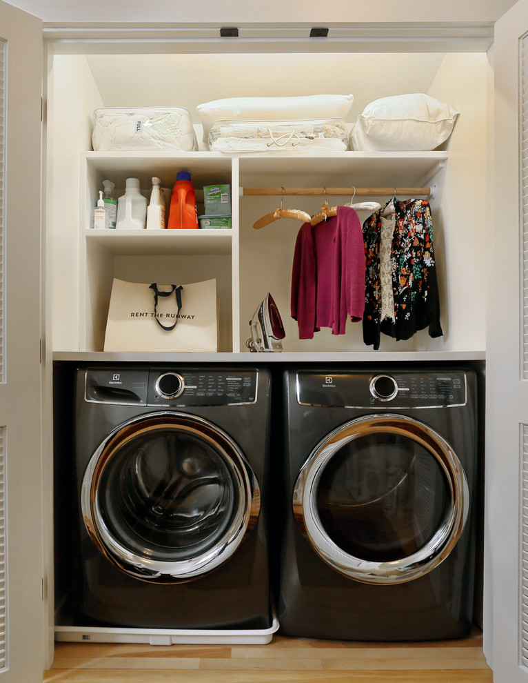 Inspiration for a small traditional single-wall laundry cupboard in Boston with open cabinets, white cabinets, wood worktops, white walls, light hardwood flooring and a side by side washer and dryer.