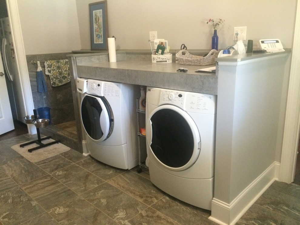 Example of a mid-sized classic single-wall slate floor utility room design in Other with gray walls, a side-by-side washer/dryer, laminate countertops and gray countertops